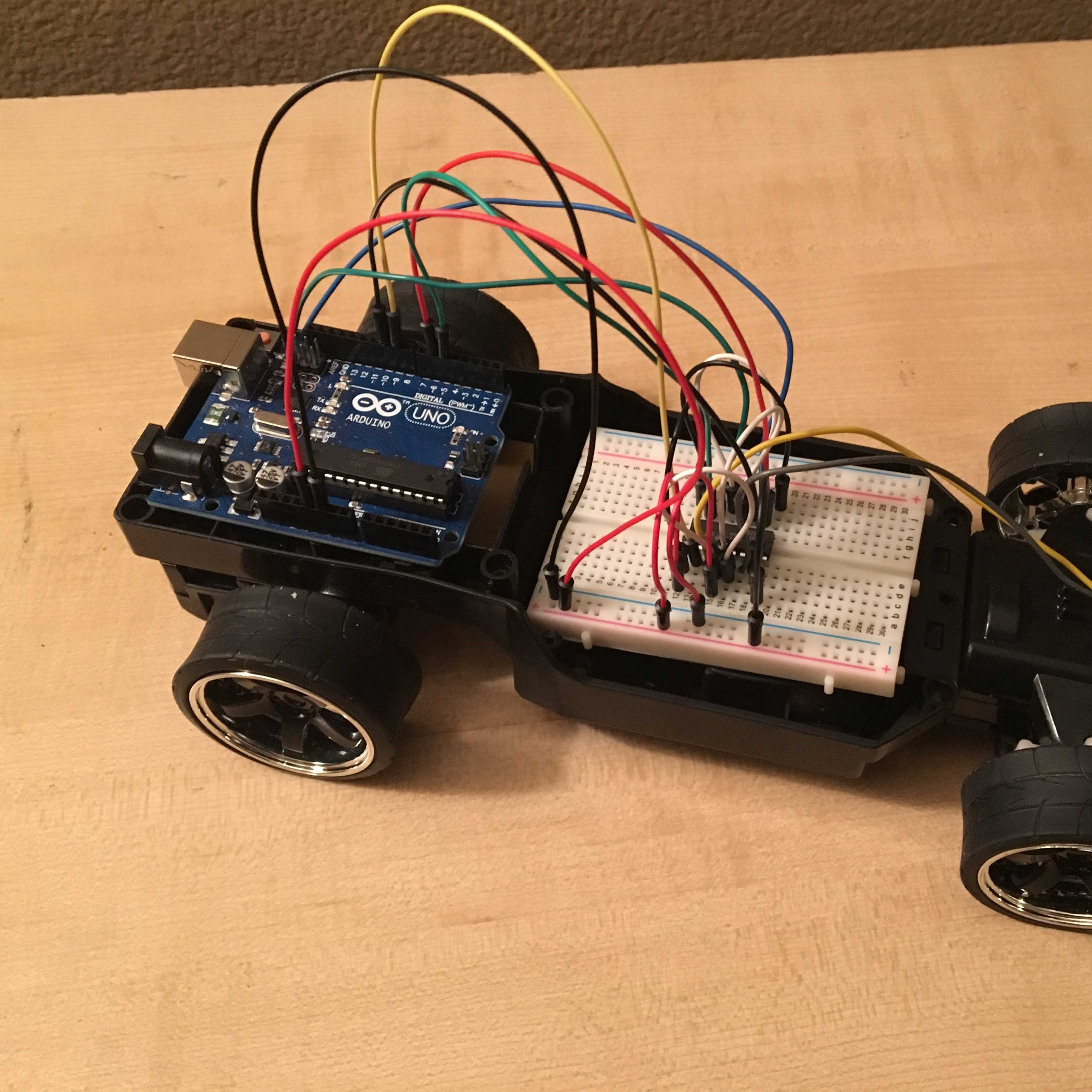 A remote control car with an Arduino microcontroller attached to it