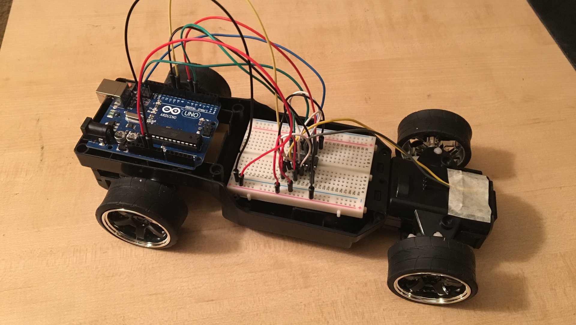 A remote control car with an Arduino microcontroller attached to it