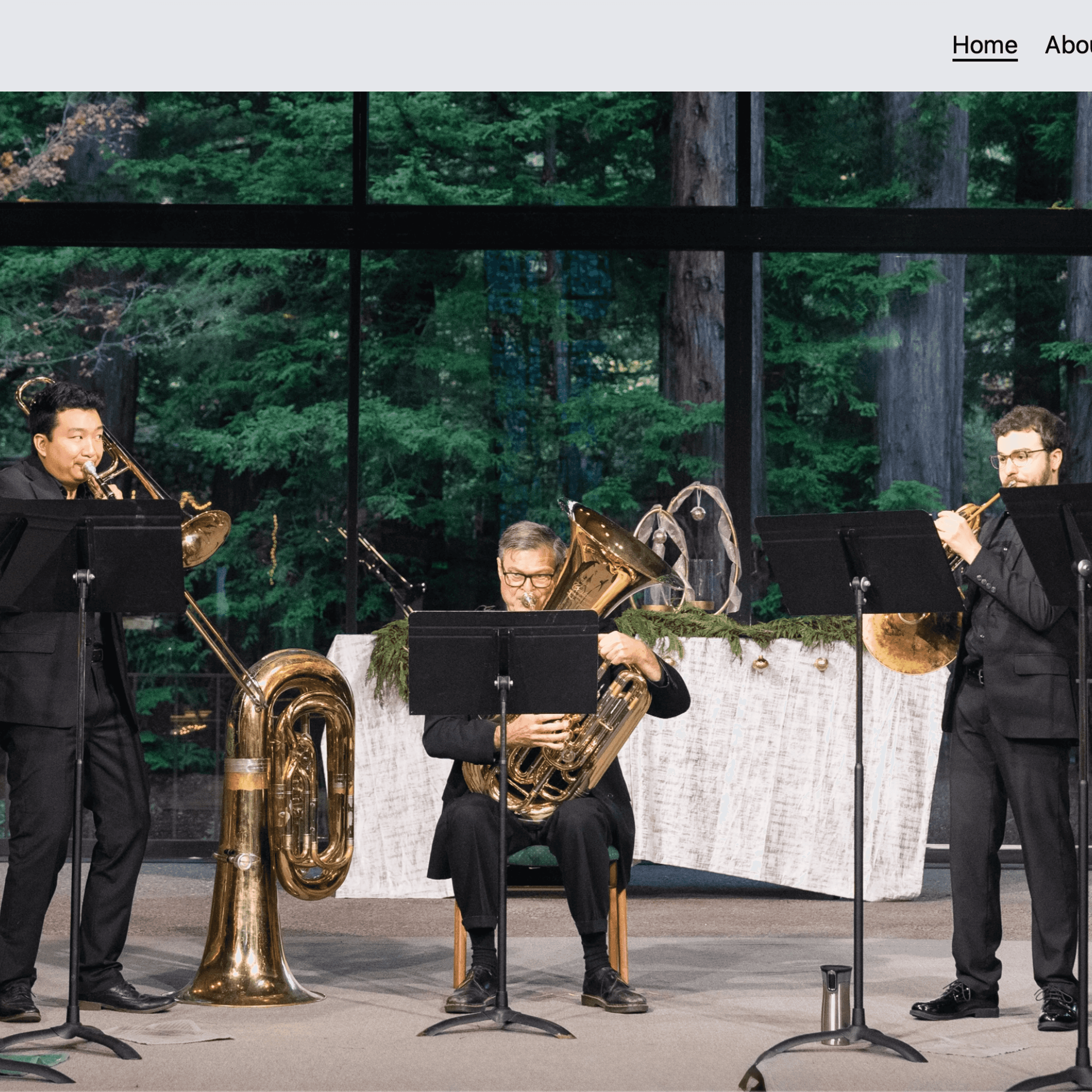 A screenshot of the Five of a Kind brass quintet website main page.